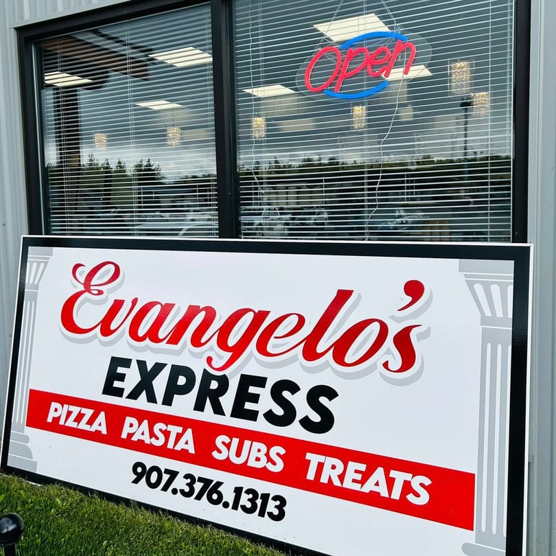 Evangelo's Express sign with "Open" neon light reflecting in the window above.